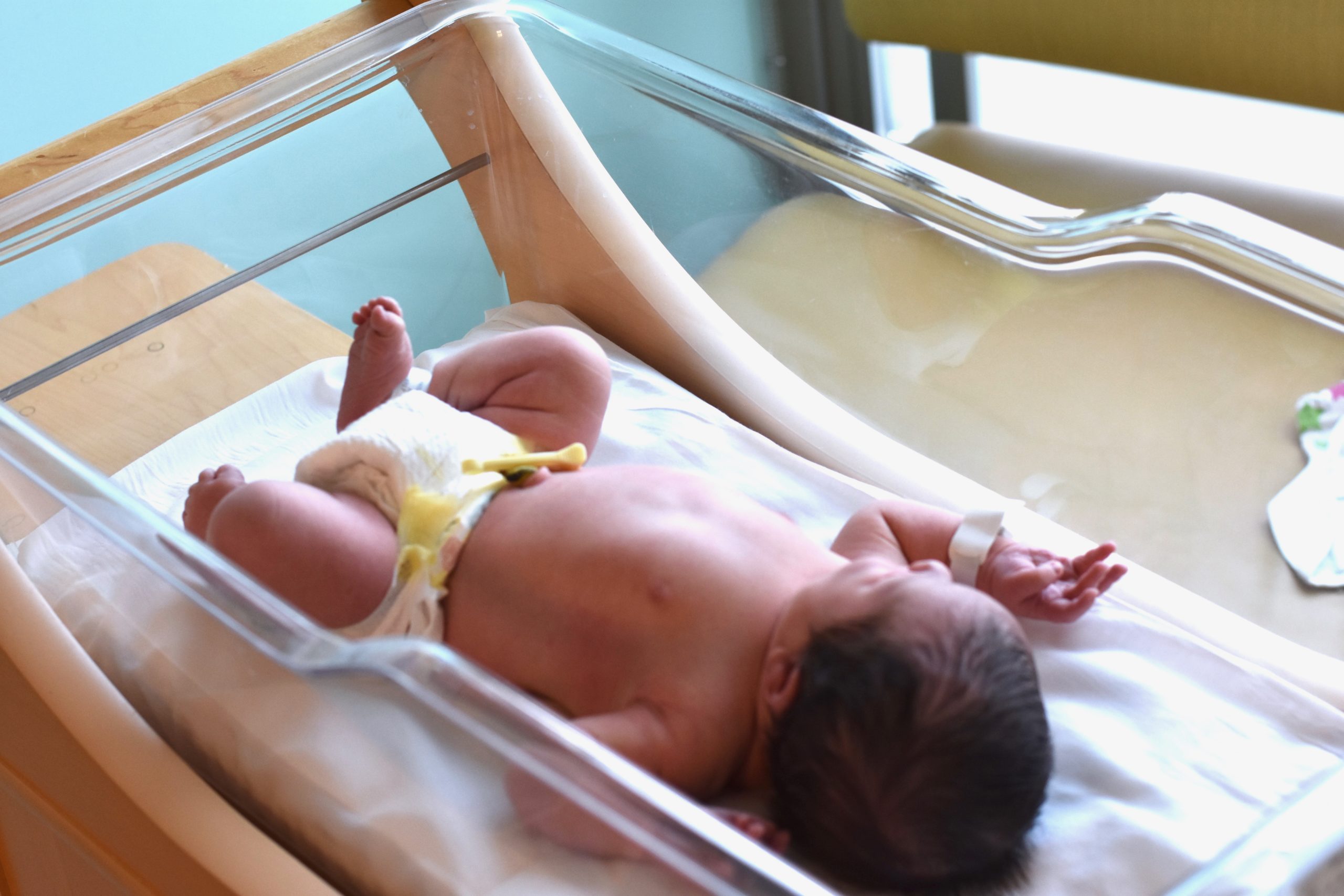 Newborn baby by window