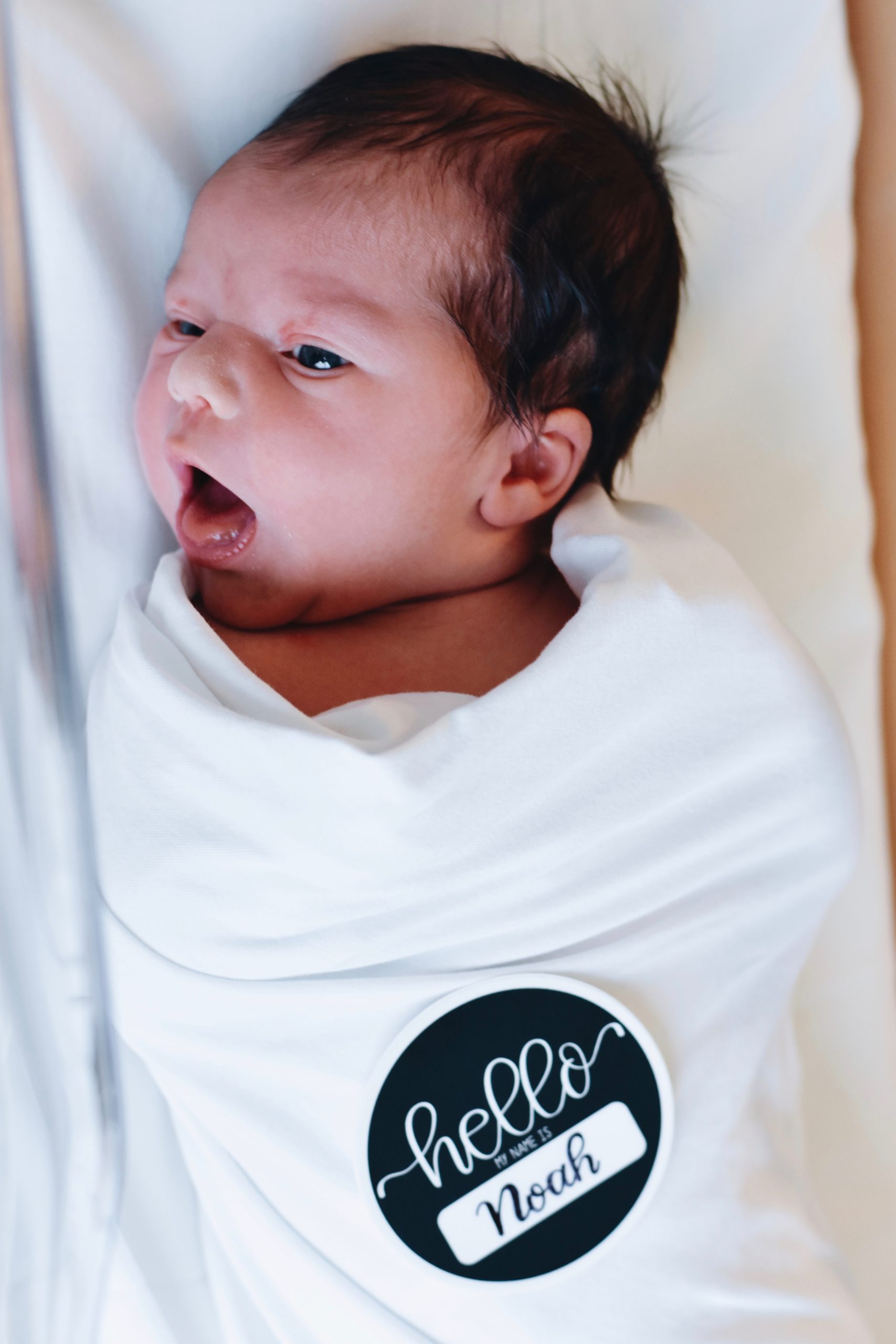Newborn baby with name tag